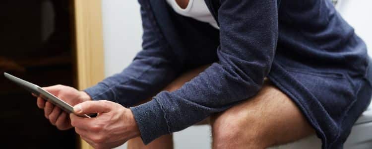 A man sitting on a toilet