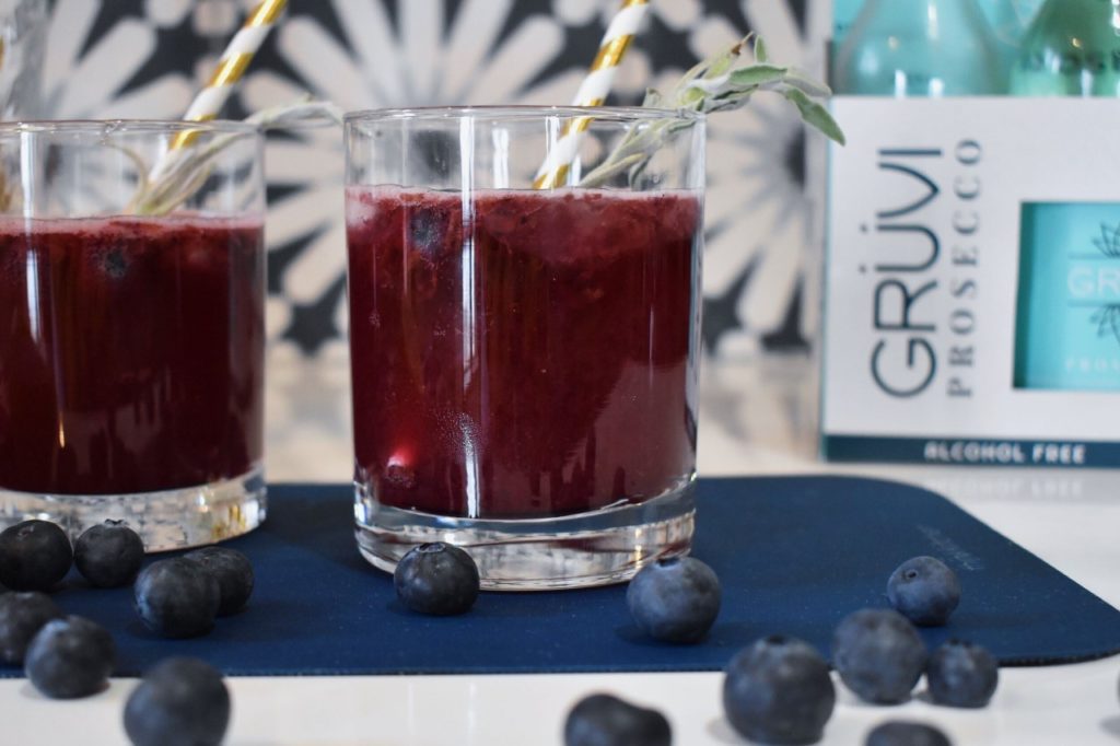 two berry bellini mocktails next to blueberries