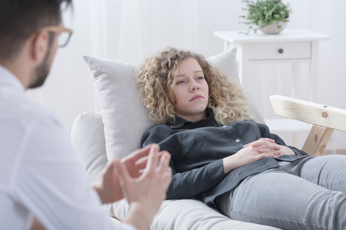 patient lying on recovery bed talking about sobriety