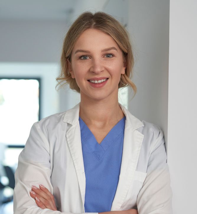 Portrait of smiling caucasian female doctor in medical clinic