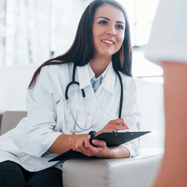 young woman visiting with female doctor