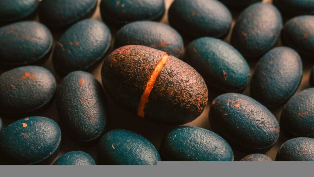 oval-pills-with-dark-colors-specks