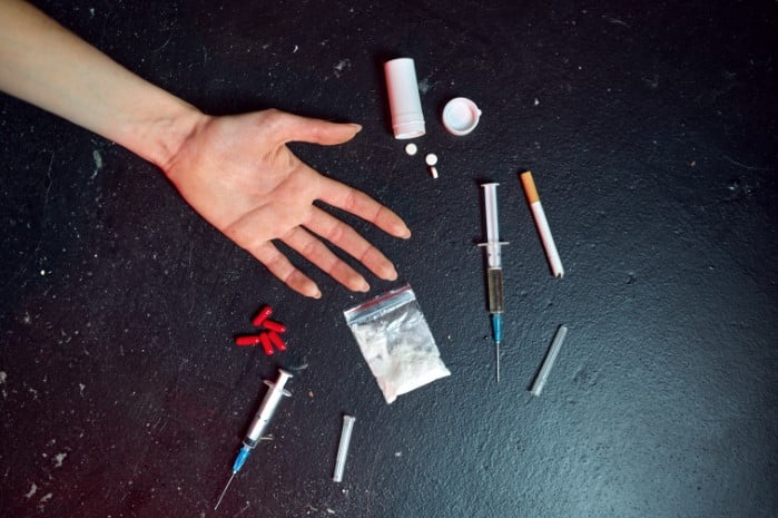 drug-addict-woman-hand-syringe-pills-and-powder-fentanyl